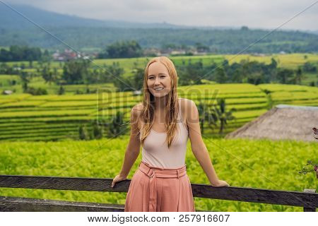 Young Woman Traveler On Beautiful Jatiluwih Rice Terraces Against The Background Of Famous Volcanoes