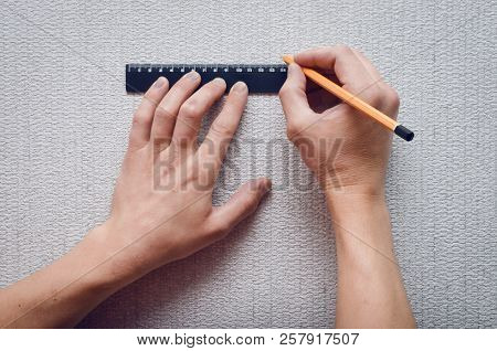 The Builder Marks On The Wall With A Ruler And Pencil The Dimensions For The Hole.