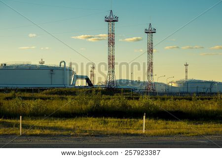 Production Containers Against A Blue Sky With Clouds