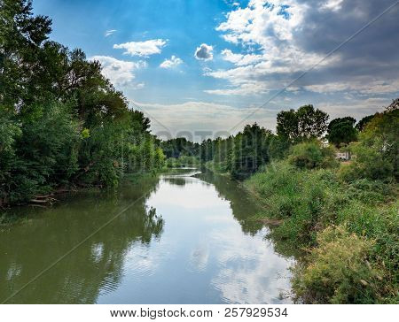 Henares River On Its Way Through The City Of Alcala De Henares In Spain With Very Green Banks And A 