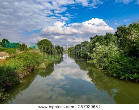 Henares River On Its Way Through The City Of Alcala De Henares In Spain With Very Green Banks And A 