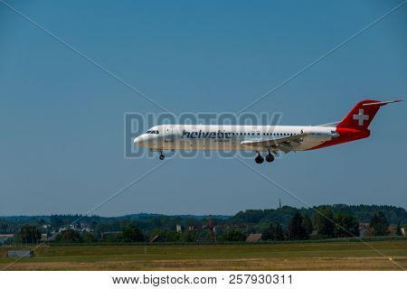Zurich, Switzerland - July 19, 2018: Helvetic Swiss airlines airplane preparing for landing at day time in Zurich nternational airport