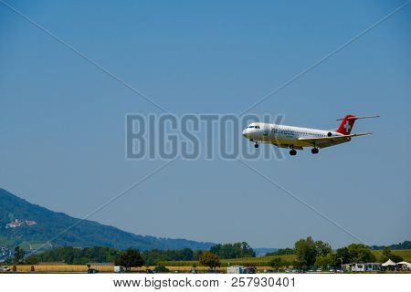 Zurich, Switzerland - July 19, 2018: Helvetic Swiss airlines airplane preparing for landing at day time in Zurich nternational airport