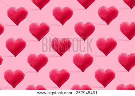 Red Heart On A Delicate Pink Background. The Concept Of Love. Heart Of The Fabric Close-up