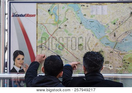 Istanbul, Turkey - December 28, 2015: Two Lost Tourists Looking And Pointing At A Map Of Istanbul Pu