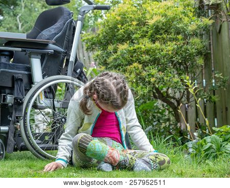 Disability A Disabled Child Relaxing In The Garden
