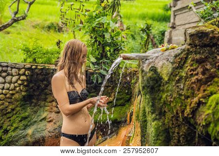 Young Woman Tourist In Belulang Hot Springs In Bali On The Background Of Rice Terraces