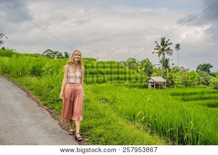 Young Woman Traveler On Beautiful Jatiluwih Rice Terraces Against The Background Of Famous Volcanoes