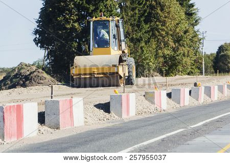 Vibratory Soil Compactor Working On Highway Construction Site.