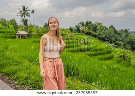 Young Woman Traveler On Beautiful Jatiluwih Rice Terraces Against The Background Of Famous Volcanoes