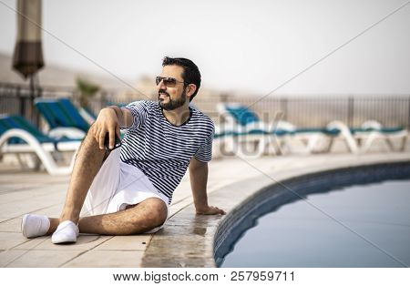 Middle Aged Arab Man Enjoying His Summer Holiday By A Pool