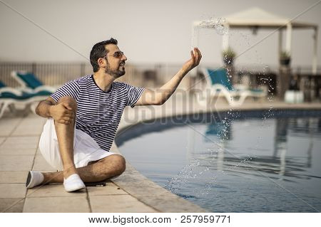 Middle Aged Arab Man Enjoying His Summer Holiday By A Pool