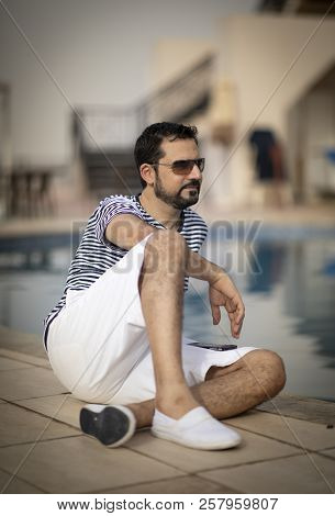 Middle Aged Arab Man Enjoying His Summer Holiday By A Pool