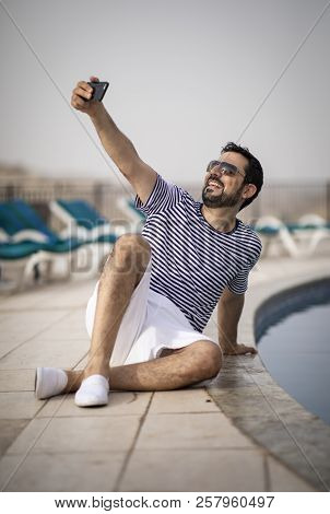 Middle Aged Arab Man Enjoying His Summer Holiday By A Pool