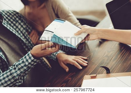 Manager In Travel Agency Giving Tickets To Couple. Consultant In Travel Office. Airplane Tickets. Fa