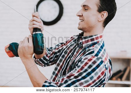 Young Man Assembling Wooden Bookshelf At Home. Wooden Bookcase. Selfmade Furniture. Man And Hobby. W