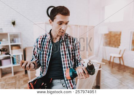 Young Man Assembling Wooden Bookshelf At Home. Wooden Bookcase. Selfmade Furniture. Man And Hobby. W