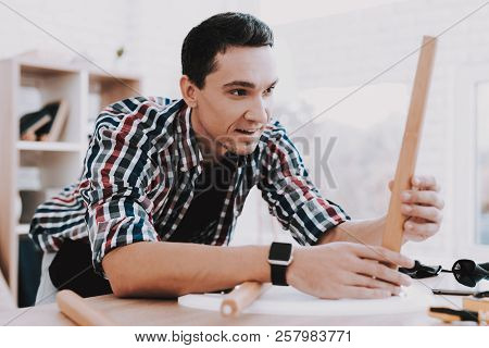 Young Man Assembling Coffee Table And Stools. Furniture Fittings. Engineer With Tool. Young Man At H