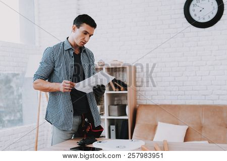 Young Man Assembling Coffee Table And Stools. Furniture Fittings. Engineer With Tool. Young Man At H