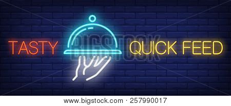 Tasty Quick Feed Sign In Neon Style. Red And Yellow Lettering, Hand Holding Dish Under Cloche. Night