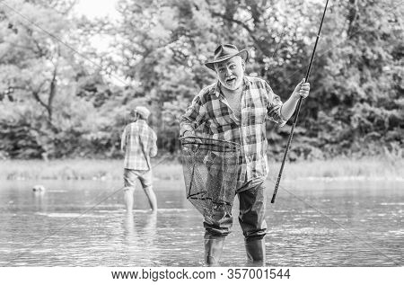 Fisherman With Fishing Rod. Activity And Hobby. Fishing Freshwater Lake Pond River. Bearded Men Catc