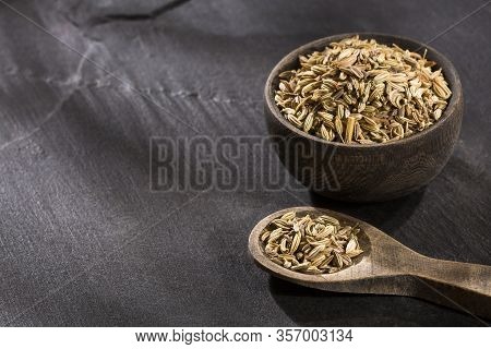 Dried Fennel Seeds In A Wooden Bowl With Wooden Spoon - Foeniculum Vulgare