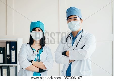 Doctor And Nurse At Clinic. Two Infectionists At Work. Diseases Outbreak Prevention And Health Care 