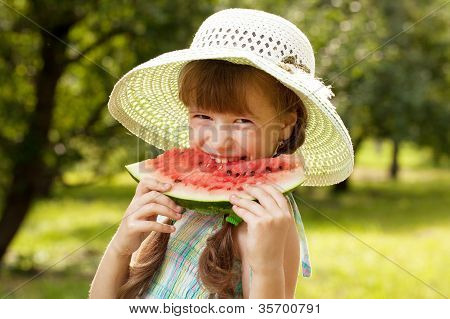 Girl In The Hat And Dress Eating A Watermelon