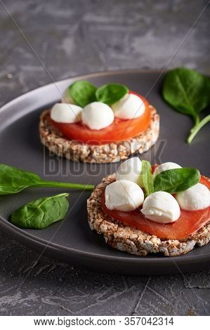 Toasts With Mozzarella, Tomatoes And Spinach In A Gray Plate
