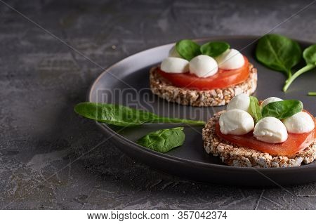 Toasts With Mozzarella, Tomatoes And Spinach In A Gray Plate