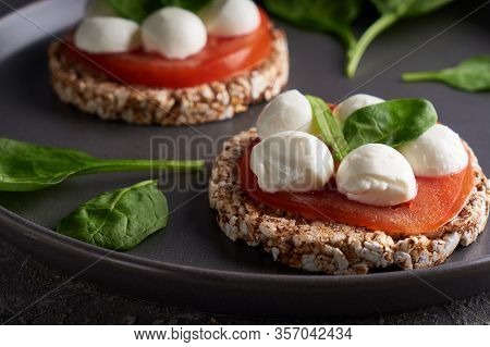 Toasts With Mozzarella, Tomatoes And Spinach In A Gray Plate