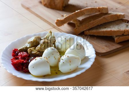 Mozzarella, Cherry Tomatoes Dried And Artichokes Seasoned With Olive Oil And Oregano With Slices Of 
