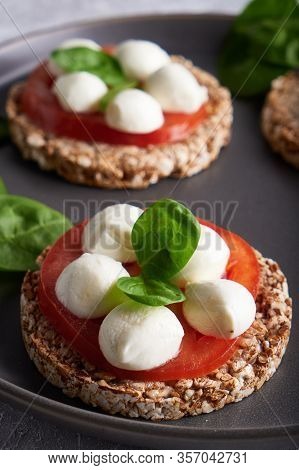 Toasts With Mozzarella, Tomatoes And Spinach In A Gray Plate