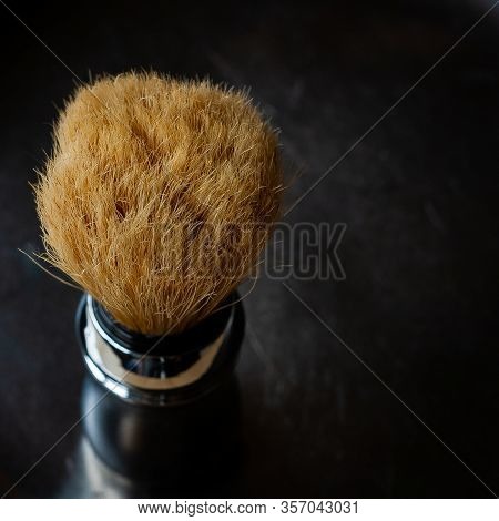 Shaving Brush On The Rustic Black Background, Top View In Chiroscuro Style. Skin Care For Men. Place