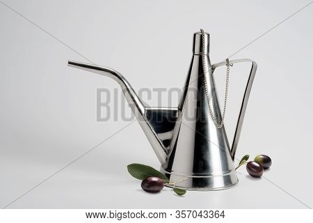 Steel Oil Cruet And Olives Isolated On White Background