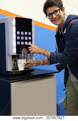Very Happy Boy Drinks Coffee At An Hot Beverage Dispenser