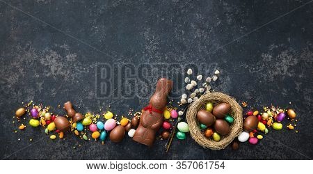 Chocolate Easter eggs on dark rustic background