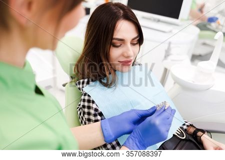 Dentist Shows Patient A Model Of Teeth