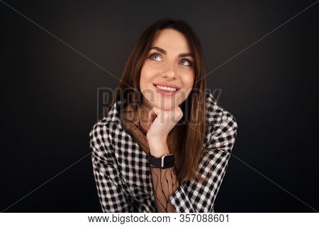 Portrait Of A Pensive Young Beautiful Woman Who Sits Leaning On Her Hand