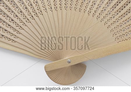 Folding Wooden Fan, Disclosed. Light Background, Close-up. Asian Traditions, China And Japan. Wood A