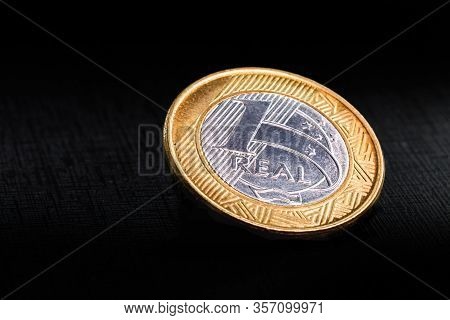 One Real Coins Isolated On Black Background. Money From Brazil. Brazil Economy Or Financial Crisis C
