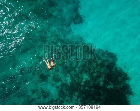 Snorkeling Couple In The Middle Of The Indian Ocean, Coral Reefs, Green Water, From High Above. Bird