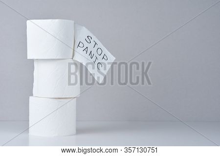 Consumer Buying Panic About Coronavirus Covid-19 Concept. Toilet Paper Rolls With Word Stop Panic