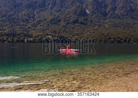 Girl Kayaking In The Scenic Bohinj Lake, Slovenia