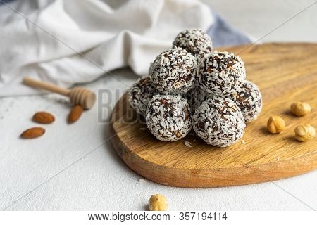 Nuts And Coconut Balls On A Wooden Board