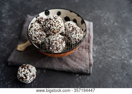 Raw Food Balls From Nuts And Dates On A Black Background