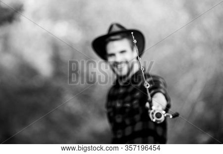 Fishing Rod Selective Focus. Happy Fisherman In Hat Blurred. Western Portrait. Vintage Style Man. Wi