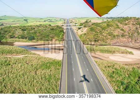 Flying Low Passing Over N2 Toll Road Dual Lanes Traffic  Wide River Overhead With Low Water Sandbank