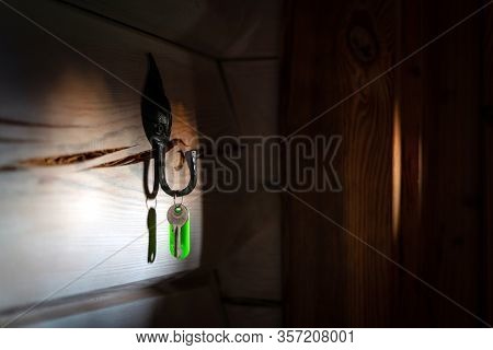 Key With Tag Hanging On The Hook By The Door In The Dark