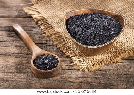 Hawaiian Black Salt In Wooden Bowl. Text Space
